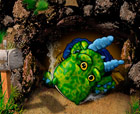 Titel: -- Edgar Dragon in the cave -- , Little green dragon sitting in front of his cave